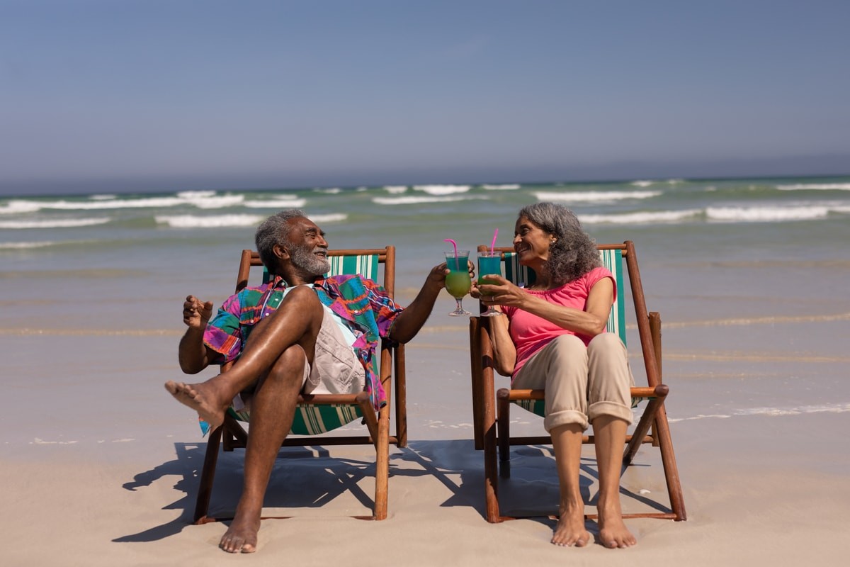 elderly couple enjoying sun on beach